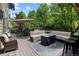 This back deck features outdoor seating with multiple cushioned sofas and chairs with a patio table at 5301 Clovervale Cir, Highlands Ranch, CO 80130