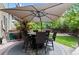Inviting back deck featuring an umbrella-covered dining table, perfect for outdoor entertaining at 5301 Clovervale Cir, Highlands Ranch, CO 80130