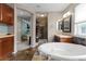 Relaxing bathroom features a soaking tub and a separate shower, perfect for unwinding after a long day at 5301 Clovervale Cir, Highlands Ranch, CO 80130