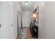 Inviting entryway with hardwood floors, console table with lamps, and a leaning mirror at 5301 Clovervale Cir, Highlands Ranch, CO 80130