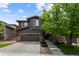 Charming two-story home features a three-car garage, stone accents, and well-maintained landscaping at 5301 Clovervale Cir, Highlands Ranch, CO 80130