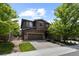Charming two-story home features a three-car garage, stone accents, and well-maintained landscaping at 5301 Clovervale Cir, Highlands Ranch, CO 80130