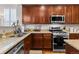 Gourmet kitchen features granite countertops, stainless steel appliances, and dark wood cabinetry at 5301 Clovervale Cir, Highlands Ranch, CO 80130
