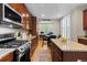 Spacious kitchen with wood floors, granite counters, stainless steel appliances, and eat in area at 5301 Clovervale Cir, Highlands Ranch, CO 80130