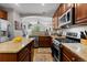 Open kitchen design includes stainless steel appliances, granite countertops, and dark wood cabinets at 5301 Clovervale Cir, Highlands Ranch, CO 80130