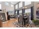 Spacious living room featuring vaulted ceilings, large windows, and a modern dining area at 5301 Clovervale Cir, Highlands Ranch, CO 80130