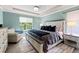 Comfortable bedroom features a tray ceiling, neutral walls, and a large window for ample natural light at 5301 Clovervale Cir, Highlands Ranch, CO 80130