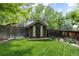 Charming backyard storage shed with a classic design and complemented by lush greenery at 5301 Clovervale Cir, Highlands Ranch, CO 80130