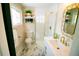 Stylish bathroom featuring a modern vanity, glass shower, and elegant marble flooring at 3040 S Clermont Dr, Denver, CO 80222