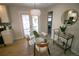 Dining room with a glass table, modern chairs, stylish lighting, and access to the patio at 3040 S Clermont Dr, Denver, CO 80222