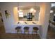 Inviting kitchen bar area with modern pendant lighting and seating, perfect for casual dining and entertaining guests at 3040 S Clermont Dr, Denver, CO 80222