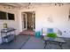 Covered patio with cozy seating, string lights, and view to interior at 3040 S Clermont Dr, Denver, CO 80222