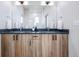 Bathroom featuring a double vanity with wood-look cabinets and sleek fixtures at 9052 Harlan St, Westminster, CO 80031