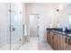 Modern bathroom featuring a glass-enclosed shower, double vanity, and stylish fixtures at 9052 Harlan St, Westminster, CO 80031