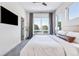 Bright bedroom featuring a ceiling fan, large window views, and a wall-mounted television at 9052 Harlan St, Westminster, CO 80031