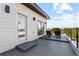 Outdoor deck with lounge chairs and a sleek black railing with a beautiful view at 9052 Harlan St, Westminster, CO 80031