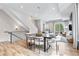 Open floor plan features dining area leading to living room with wood flooring throughout at 9052 Harlan St, Westminster, CO 80031