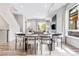 Bright dining area boasts modern light fixtures, stylish seating and wood flooring throughout at 9052 Harlan St, Westminster, CO 80031