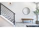 Inviting entryway with stylish bench, mirror, staircase, and modern decor at 9052 Harlan St, Westminster, CO 80031
