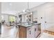 Modern kitchen with a center island, stainless steel dishwasher, and an open concept design at 9052 Harlan St, Westminster, CO 80031