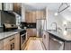Modern kitchen with stainless steel appliances and sleek countertops at 9052 Harlan St, Westminster, CO 80031