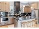 Well-appointed kitchen with stainless steel appliances, island seating, and ample counter space at 9052 Harlan St, Westminster, CO 80031