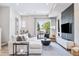 Bright living room featuring a modern sectional sofa, stylish decor, and a sliding glass door to a balcony at 9052 Harlan St, Westminster, CO 80031