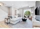 Bright living room features a sliding glass door to outdoor space and stylish decor at 9052 Harlan St, Westminster, CO 80031