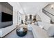 Open concept living room and kitchen offers natural light and wood flooring throughout at 9052 Harlan St, Westminster, CO 80031