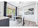 Bright office space with modern desk, stylish art, and sliding glass doors to an outdoor space at 9052 Harlan St, Westminster, CO 80031