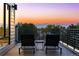 Relax on this rooftop deck featuring mountain views, lounge seating and modern railings at 9052 Harlan St, Westminster, CO 80031