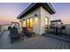 Relaxing rooftop deck with lounge chairs, bar seating, and modern lighting at 9052 Harlan St, Westminster, CO 80031