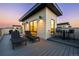 Spacious rooftop deck with comfortable lounge chairs and modern bar for relaxing and entertaining at 9052 Harlan St, Westminster, CO 80031
