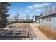 Backyard featuring garden beds, a manicured lawn, and a brick patio, perfect for outdoor enjoyment at 8622 S Everett St, Littleton, CO 80128