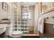 Stylish bathroom featuring a glass block shower partition and neutral-toned tiles at 8622 S Everett St, Littleton, CO 80128