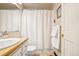 Clean bathroom with a shower and tub combination, white vanity, and framed mirror at 8622 S Everett St, Littleton, CO 80128