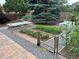 A backyard garden featuring raised garden beds, gravel pathways, and a variety of vegetables and foliage at 8622 S Everett St, Littleton, CO 80128