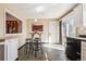 Bright eat-in kitchen featuring a breakfast bar, tile floors, and an exterior door at 8622 S Everett St, Littleton, CO 80128