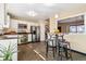 Open kitchen showcasing stainless steel appliances, breakfast bar and tile floors at 8622 S Everett St, Littleton, CO 80128