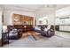 Inviting living room featuring a comfortable leather sofa, shelving and view of the kitchen at 8622 S Everett St, Littleton, CO 80128