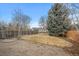 Fenced backyard featuring gravel, a grass lawn, and a bricked fire pit at 1668 Holeman Dr, Erie, CO 80516