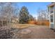 Backyard featuring lawn, gravel, and a brick fire pit at 1668 Holeman Dr, Erie, CO 80516