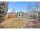 Spacious backyard showcasing lawn, mature trees, and landscaping at 1668 Holeman Dr, Erie, CO 80516