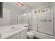 Bathroom featuring vanity, toilet, and shower/tub combo with sliding glass doors at 1668 Holeman Dr, Erie, CO 80516