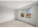 Neutral bedroom with a large window providing natural light at 1668 Holeman Dr, Erie, CO 80516