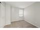 Cozy bedroom with neutral carpet, closet, and a window at 1668 Holeman Dr, Erie, CO 80516