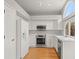 Bright kitchen featuring white cabinetry, stainless steel appliances, and wood floors at 1668 Holeman Dr, Erie, CO 80516