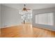 Bright living room flows into kitchen with hardwood floors and big windows at 1668 Holeman Dr, Erie, CO 80516