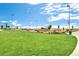 Beautiful outdoor space with lush green grass, rock features, and scenic walking paths for residents at 1668 Holeman Dr, Erie, CO 80516