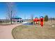 Community playground featuring colorful play equipment, picnic shelter, and expansive green space at 1668 Holeman Dr, Erie, CO 80516